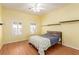 Cozy bedroom featuring a ceiling fan, two windows, and floating shelves at 10709 Brinkwood Ave, Las Vegas, NV 89134