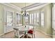 Charming dining area with a white table, ample natural light, and access to the outdoors at 10709 Brinkwood Ave, Las Vegas, NV 89134