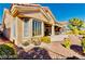 Home exterior featuring desert landscaping, stucco siding, and tile roof at 10709 Brinkwood Ave, Las Vegas, NV 89134