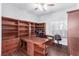 Spacious home office with custom built-in shelving, wood floors, and natural light from the window at 10709 Brinkwood Ave, Las Vegas, NV 89134