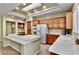 Spacious kitchen featuring a center island, stainless steel appliances, and warm cabinetry at 10709 Brinkwood Ave, Las Vegas, NV 89134