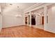 Spacious living room featuring hardwood floors, decorative columns, and elegant lighting at 10709 Brinkwood Ave, Las Vegas, NV 89134