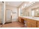 Main bathroom featuring double sinks, a glass shower enclosure, and a soaking tub at 10709 Brinkwood Ave, Las Vegas, NV 89134