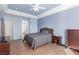 Comfortable main bedroom showing a bed, dresser, wood-like floors, and ample space at 10709 Brinkwood Ave, Las Vegas, NV 89134