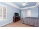 Bright main bedroom with wood-like floors and a TV, offering a comfortable and inviting atmosphere at 10709 Brinkwood Ave, Las Vegas, NV 89134