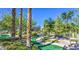 Landscaped miniature golf course with winding paths, lush greenery, and palm trees at 10709 Brinkwood Ave, Las Vegas, NV 89134