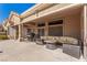 Covered patio boasts a cozy seating area with a fire pit, perfect for outdoor entertaining at 10709 Brinkwood Ave, Las Vegas, NV 89134