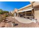 An inviting patio features comfortable seating and a retractable awning overlooking the landscaped backyard at 10709 Brinkwood Ave, Las Vegas, NV 89134