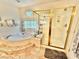 Bathroom featuring a shower with gold trim and tiled flooring at 11027 Dornoch Castle St, Las Vegas, NV 89141