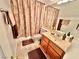 This bathroom includes a single vanity and a shower with decorative brown curtain at 11027 Dornoch Castle St, Las Vegas, NV 89141