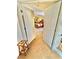 View of a bedroom from the upstairs hallway with an open door, neutral carpet, and yellow walls at 11027 Dornoch Castle St, Las Vegas, NV 89141