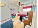 Cozy bedroom featuring a ceiling fan, neutral carpet and red accents at 11027 Dornoch Castle St, Las Vegas, NV 89141