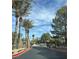 Gated community entrance with lush landscaping and mature palm trees at 11027 Dornoch Castle St, Las Vegas, NV 89141