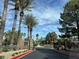 Gated community entrance surrounded by palm trees and well-maintained landscaping at 11027 Dornoch Castle St, Las Vegas, NV 89141