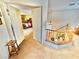 View of a bedroom from the upstairs hallway with an open door and wooden staircase with neutral carpet at 11027 Dornoch Castle St, Las Vegas, NV 89141