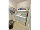 Functional laundry room with washer, dryer, storage shelves and basket at 11027 Dornoch Castle St, Las Vegas, NV 89141