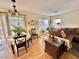 Cozy living area with laminate flooring, a dining area and lots of natural light at 11027 Dornoch Castle St, Las Vegas, NV 89141