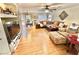 Spacious living room with hardwood floors, a ceiling fan, and lots of natural light at 11027 Dornoch Castle St, Las Vegas, NV 89141