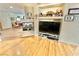 Bright living room featuring a tiled fireplace, built-in shelving, and modern entertainment setup on wood floors at 11027 Dornoch Castle St, Las Vegas, NV 89141