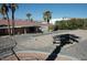 This backyard features desert landscaping, mature palm trees, and a picnic table at 1108 Sidehill Way, Las Vegas, NV 89110