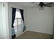 Bedroom featuring a window with blinds and colorful blue curtains at 1108 Sidehill Way, Las Vegas, NV 89110