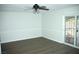 Bedroom featuring wood-look floors and backyard access with security door at 1108 Sidehill Way, Las Vegas, NV 89110