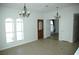 Inviting living space showcasing neutral paint, tile flooring, arched windows, and a decorative front door at 1108 Sidehill Way, Las Vegas, NV 89110