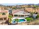 Aerial view of the home showcasing a tile roof, covered patio, pool and spa at 1223 Casa Palermo Cir, Henderson, NV 89011