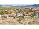 An aerial view shows a charming residential area with beautiful homes, pools, and mountain views at 1223 Casa Palermo Cir, Henderson, NV 89011