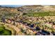 Expansive aerial view of a desert community showcasing lush landscaping, a golf course, and mountain views at 1223 Casa Palermo Cir, Henderson, NV 89011