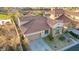 A high angle view shows a single story stucco home, desert landscaping, and a terracotta tile roof at 1223 Casa Palermo Cir, Henderson, NV 89011