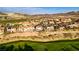 Beautiful aerial view of a desert community with lush green landscaping and scenic mountain backdrop at 1223 Casa Palermo Cir, Henderson, NV 89011