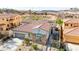 Aerial view showcasing the home's tile roof, three-car garage, and desert landscaping at 1223 Casa Palermo Cir, Henderson, NV 89011