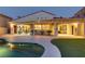 Exterior view of a home with a covered patio overlooking the sparkling pool at 1223 Casa Palermo Cir, Henderson, NV 89011