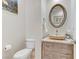 Elegant powder room features an oval mirror and vessel sink with stylish vanity at 1223 Casa Palermo Cir, Henderson, NV 89011