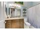 Charming blue bathroom featuring wood cabinets, decor, and a bathtub with shower at 1223 Casa Palermo Cir, Henderson, NV 89011