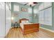 Cozy bedroom featuring a wood bed frame, plank floors, and a sunny window at 1223 Casa Palermo Cir, Henderson, NV 89011