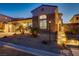 Elegant home featuring stone accents, a large arched window and mature landscaping at 1223 Casa Palermo Cir, Henderson, NV 89011