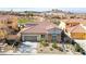 Exterior showcasing desert landscaping, a two-car garage, and a tiled roof with mountain views at 1223 Casa Palermo Cir, Henderson, NV 89011