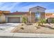 Charming home with stone accents, desert landscaping, and a two-car garage at 1223 Casa Palermo Cir, Henderson, NV 89011