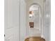 Bright hallway leads to the bathroom featuring tile flooring, wood accents, and an archway entrance at 1223 Casa Palermo Cir, Henderson, NV 89011