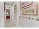 Bright hallway decorated with colorful artwork and glass accents on a display shelf at 1223 Casa Palermo Cir, Henderson, NV 89011