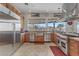 Bright kitchen with stainless steel appliances, custom cabinets, and granite countertops at 1223 Casa Palermo Cir, Henderson, NV 89011