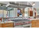 Kitchen featuring a stainless steel range hood and oven range set against a backdrop of natural wood cabinets at 1223 Casa Palermo Cir, Henderson, NV 89011