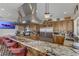 Spacious kitchen featuring a large island, stainless steel appliances, and granite countertops at 1223 Casa Palermo Cir, Henderson, NV 89011