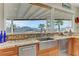 Close up of kitchen with stainless steel sink, granite countertops, and backyard views at 1223 Casa Palermo Cir, Henderson, NV 89011