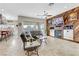 Open living room with fireplace and bar, leading to the backyard at 1223 Casa Palermo Cir, Henderson, NV 89011