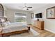 This main bedroom features wood floors, ceiling fan, and sliding glass door leading to the backyard at 1223 Casa Palermo Cir, Henderson, NV 89011