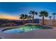 Backyard pool and spa area featuring clear water reflecting a colorful sky, perfect for relaxation at 1223 Casa Palermo Cir, Henderson, NV 89011