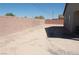 Spacious backyard with brick perimeter wall and potential for landscaping or outdoor living at 1580 S Outlaw St, Pahrump, NV 89060